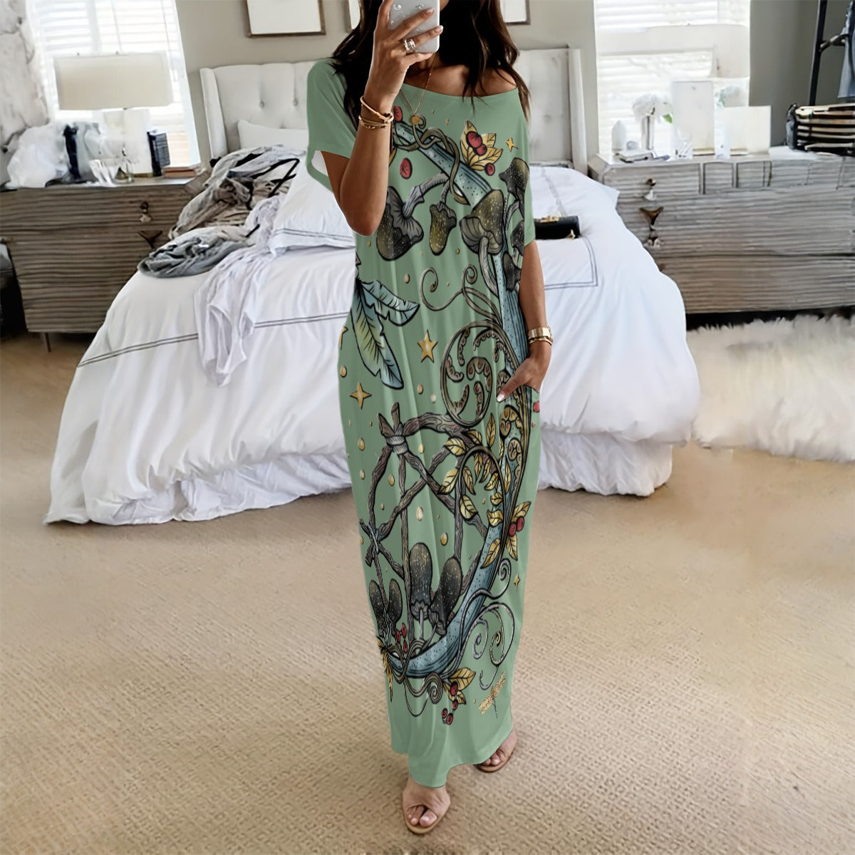 Woman wearing a long, patterned dress in a bedroom setting
