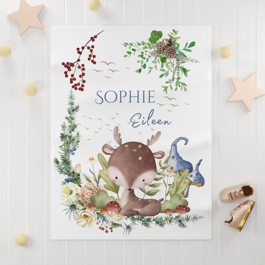 Children's blanket with a deer illustration and floral elements on a white background